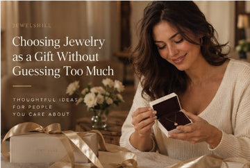 Woman opening a Jewelshill jewelry gift box at a table.